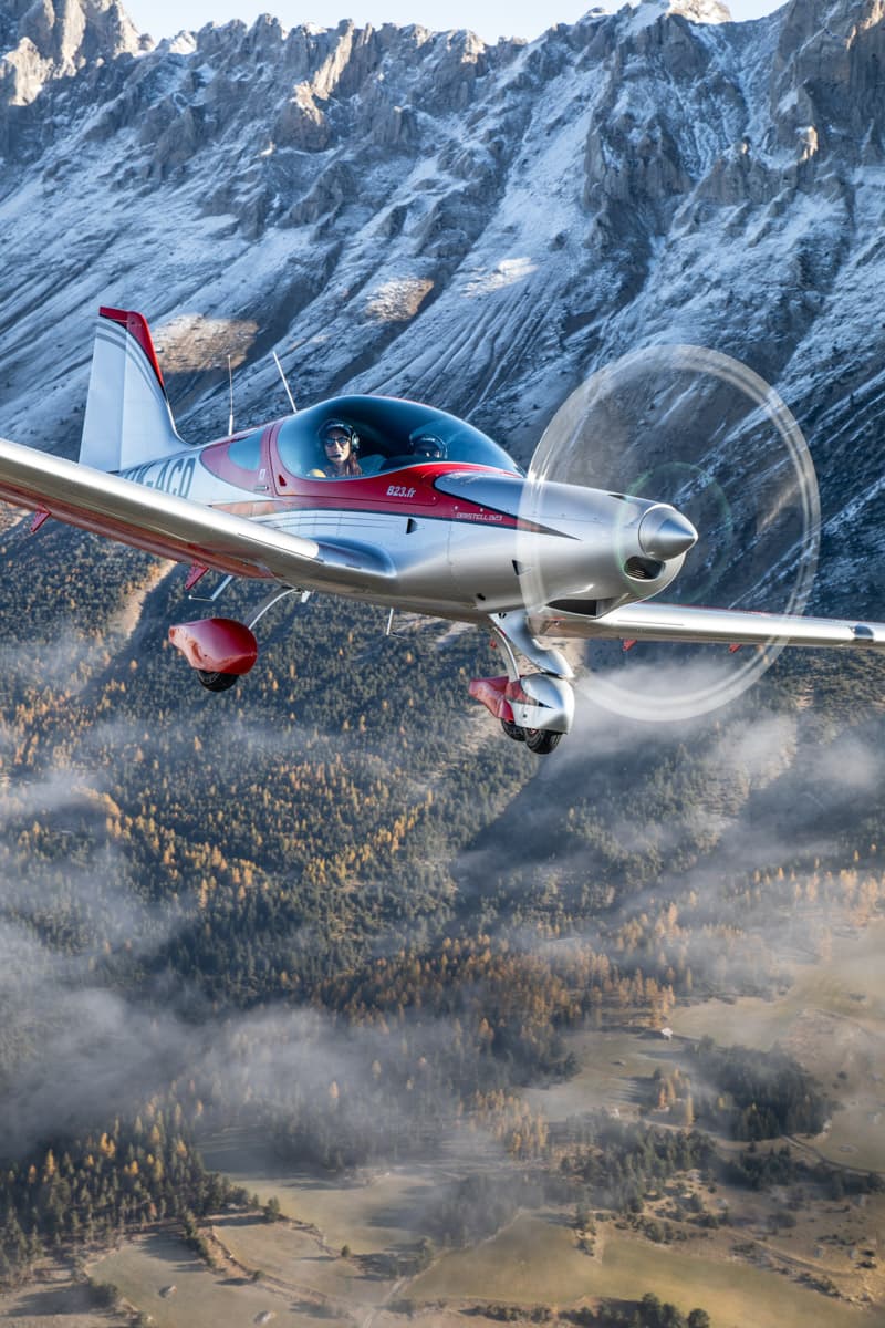 Bristell B23 banking in front of the Dolomites