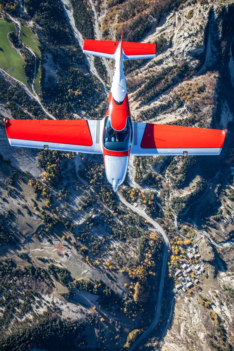 Top-down view of the Bristell B23 over an alpine valley