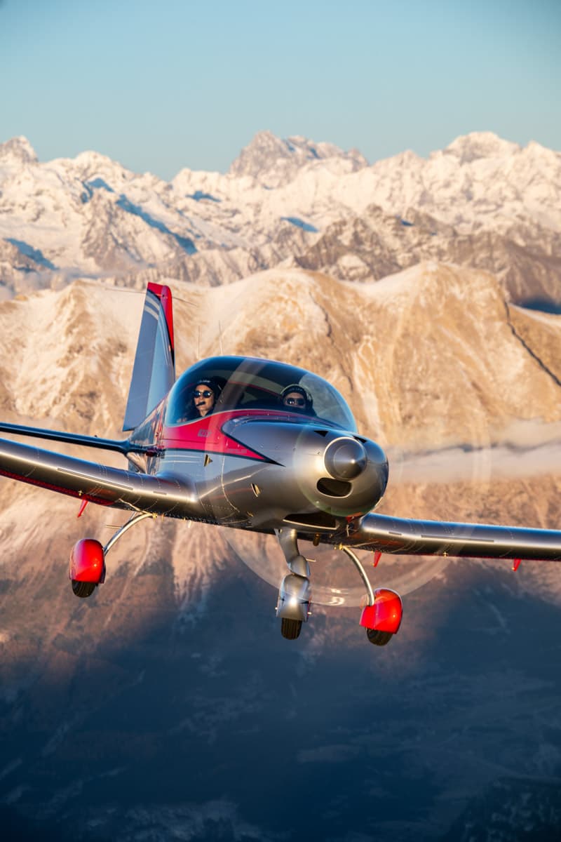 Bristell B23 Mosaic climbing past alpine peaks
