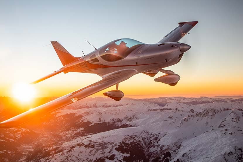 Bristell B23 Turbo in flight at sunset above the mountains