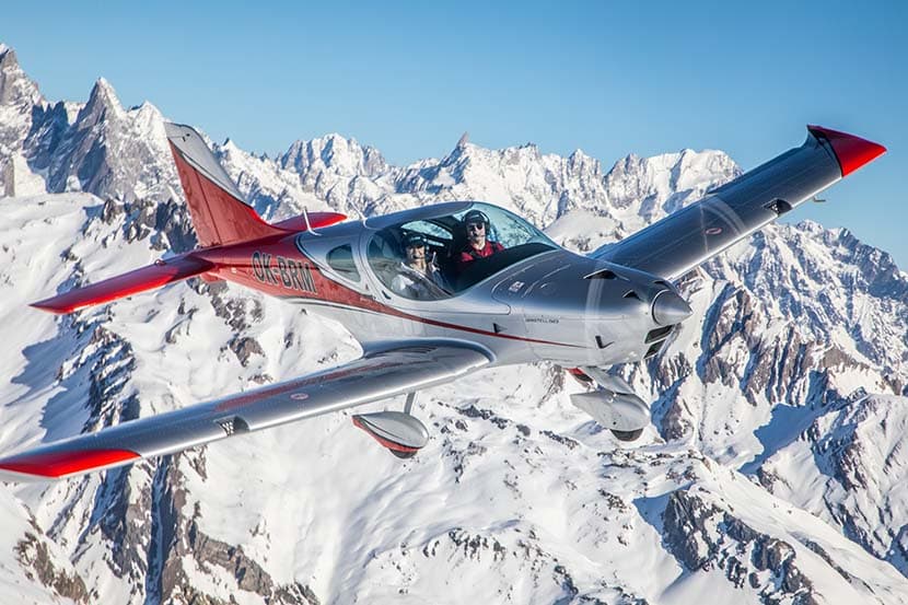 Bristell B23 Turbo banking in front of the snow-capped Alps