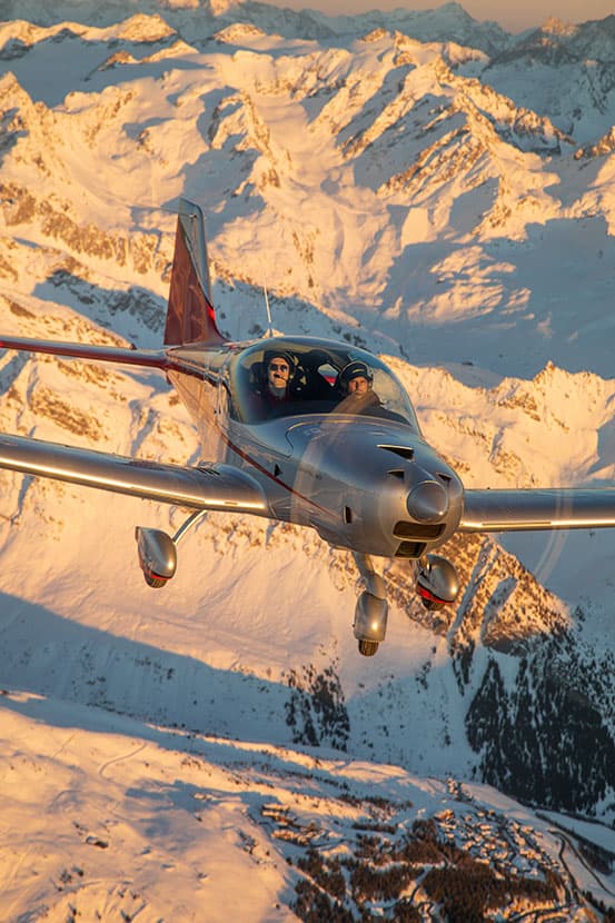 Bristell B23 Turbo with two on board over the Alps at golden hour