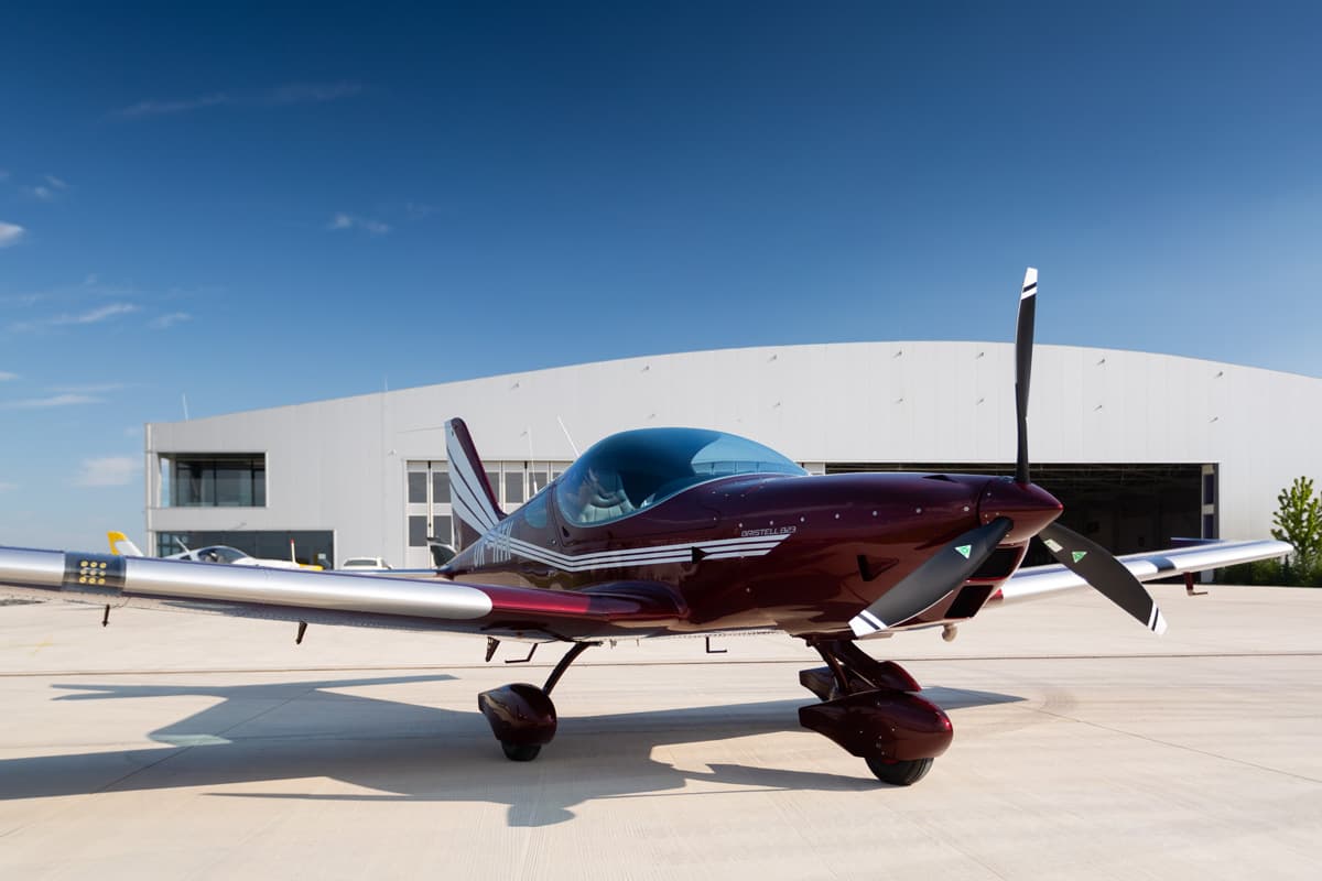 Bristell B23 Turbo front view parked in front of a hangar