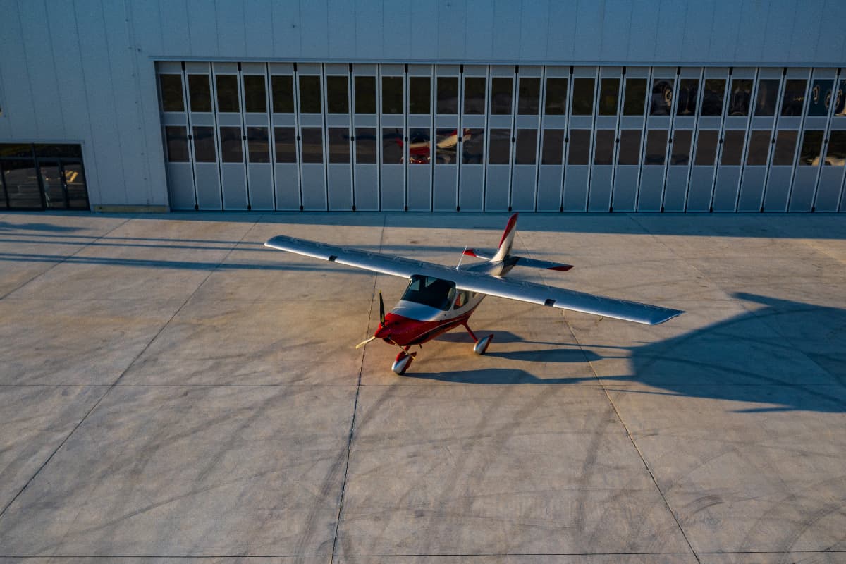 Bristell B8 parked on the apron in front of the hangar