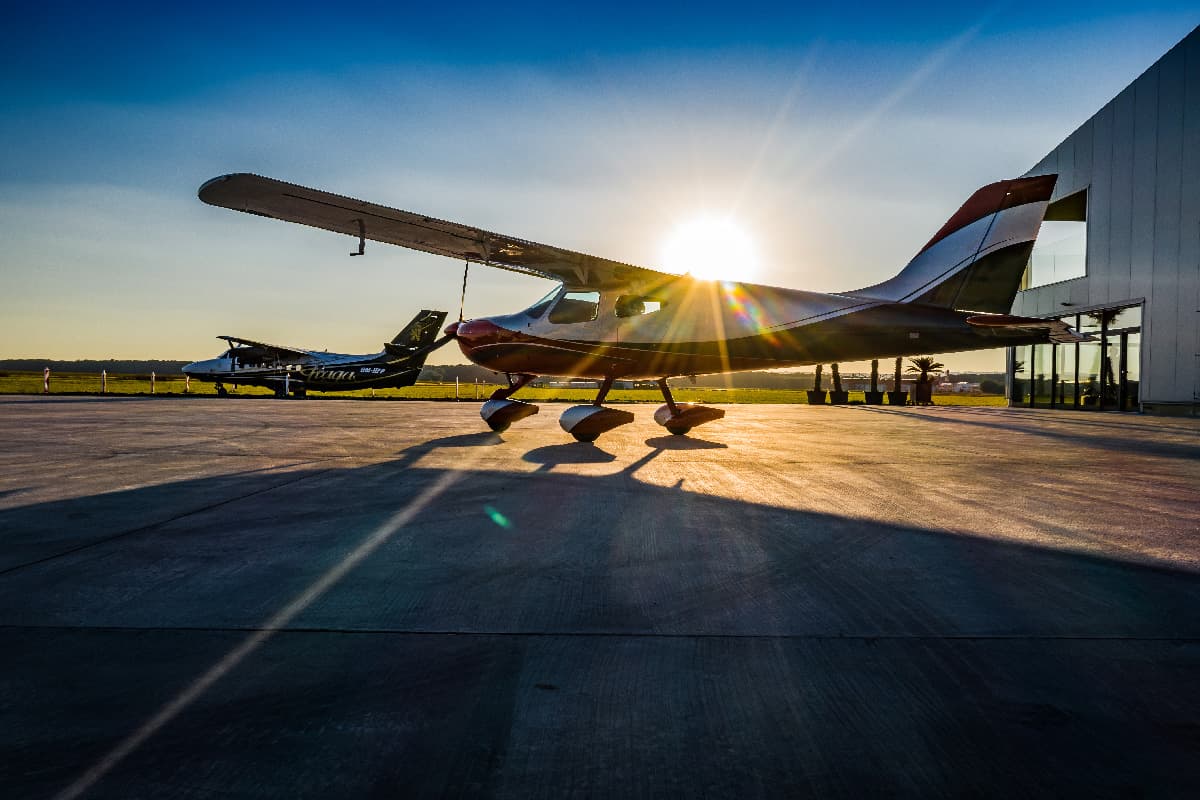 Bristell B8 silhouetted against the setting sun on the apron