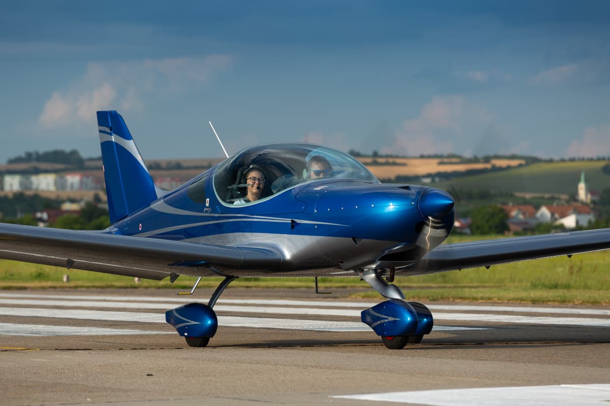 Blue metallic Bristell Classic taxiing on the apron