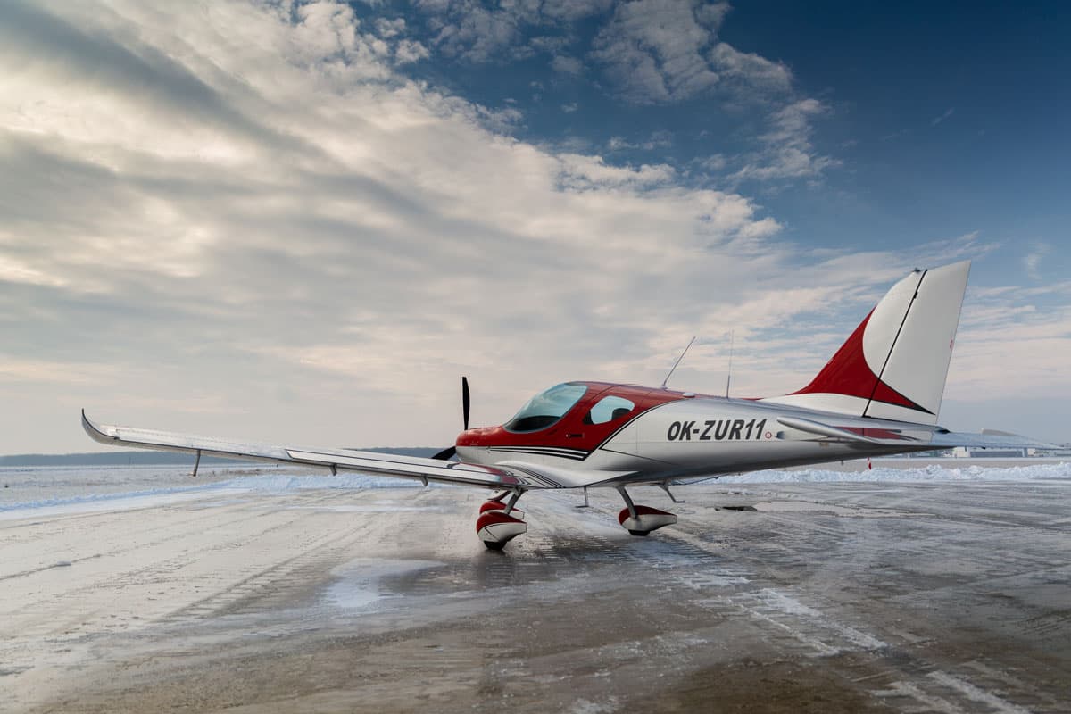 Red Bristell Classic on a snow-lined ramp under big skies