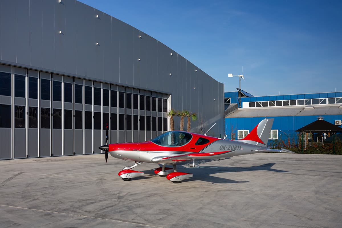 Red Bristell Classic parked under a clear sky