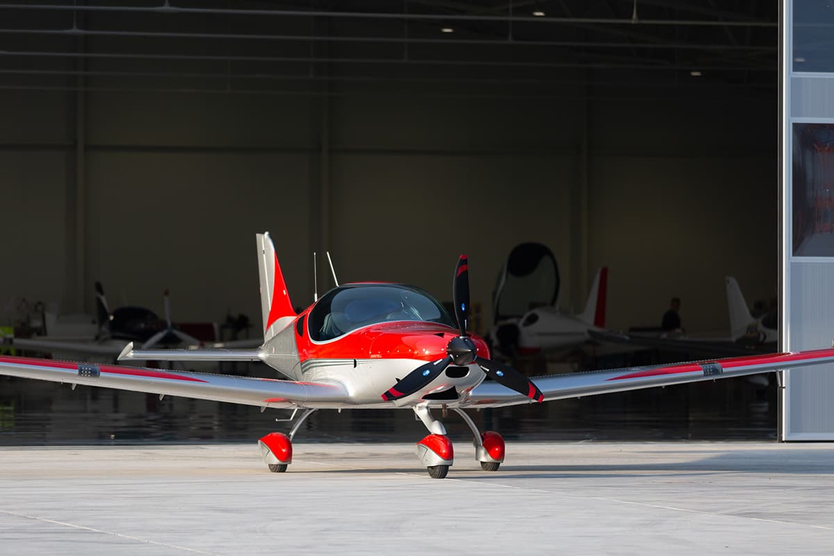 Red Bristell Classic head-on at the hangar