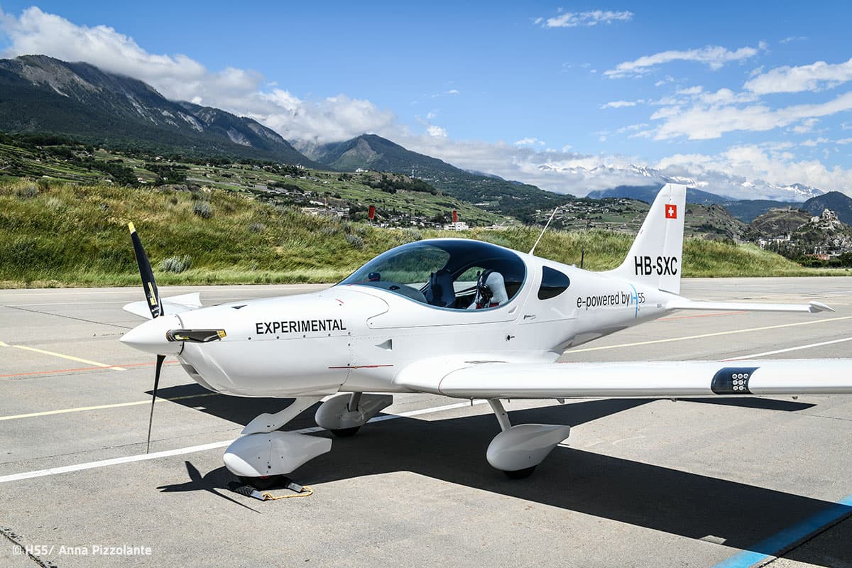 Bristell Energic electric trainer on the apron with the Alps behind