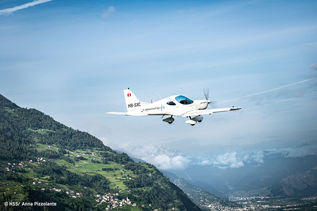 Bristell Energic flying over a Swiss alpine valley
