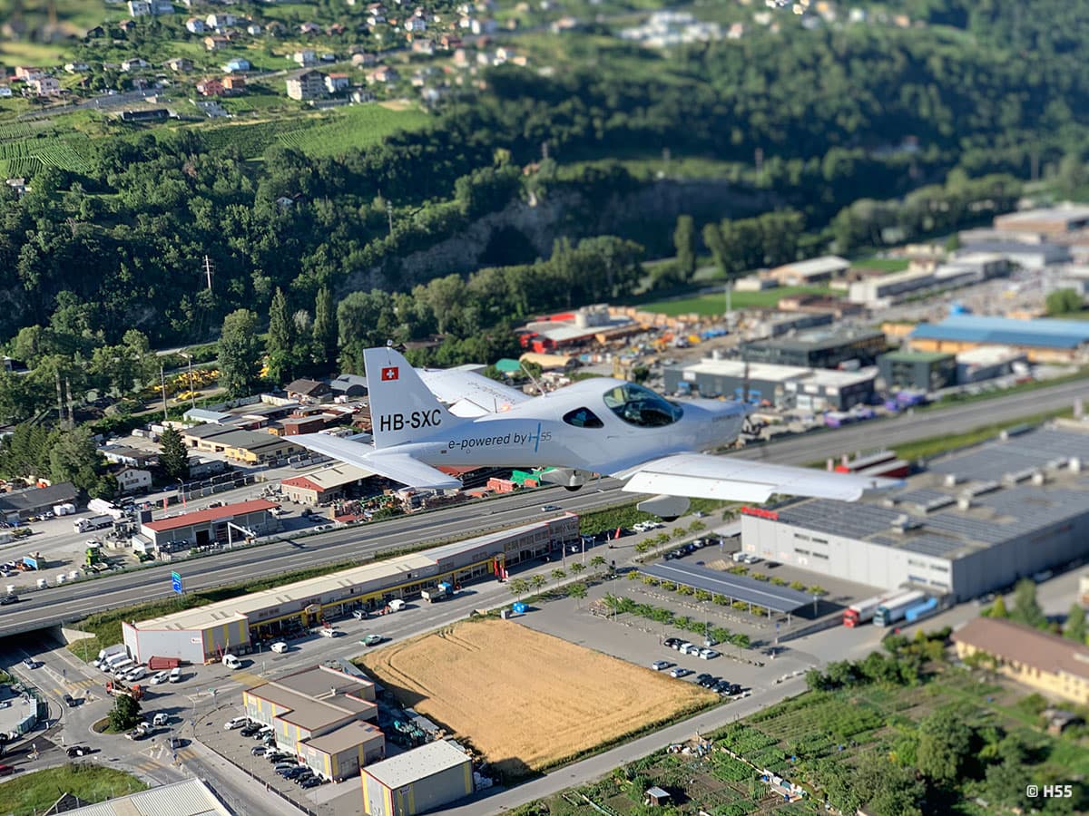 Bristell Energic banking in flight above a Swiss valley