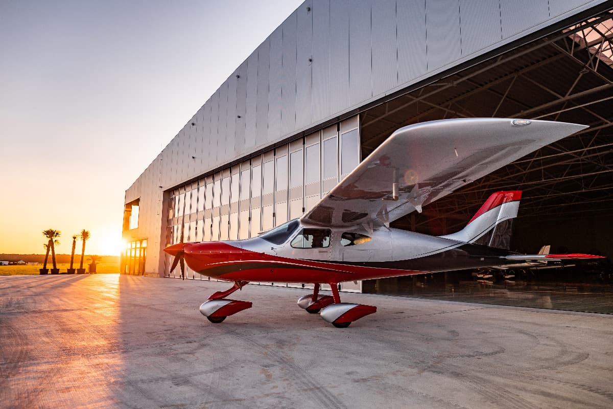 Bristell B8 parked at the hangar entrance at sunset